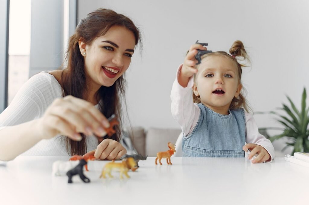 A joyful moment of a mother and daughter playing with toy animals indoors.